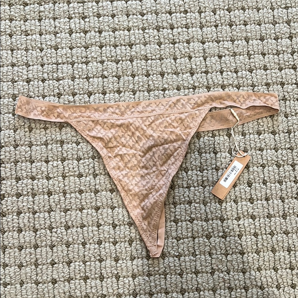 SKIMS Logo Mesh Thong in Nude/Tan Sheer